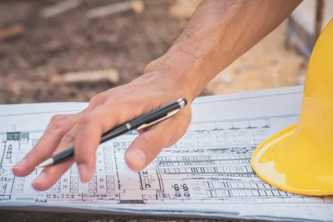 Closeup hand write on blueprint paperwork document designer building construc Stock Photos