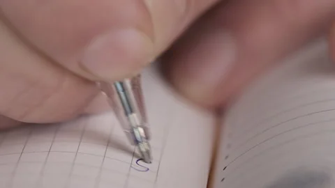 Closeup of hand writing with a pen Stock Footage 168751793