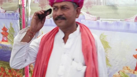 Closeup handheld of a man making a call and talking on the phone Stock Footage 69786233