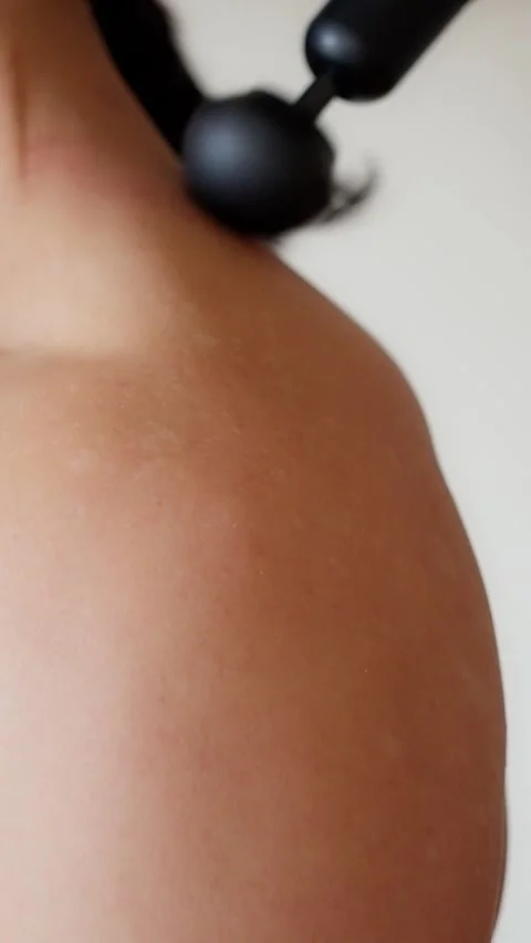 Closeup of a handheld massager designed to relieve muscle tension and promote Stock Footage 308863983