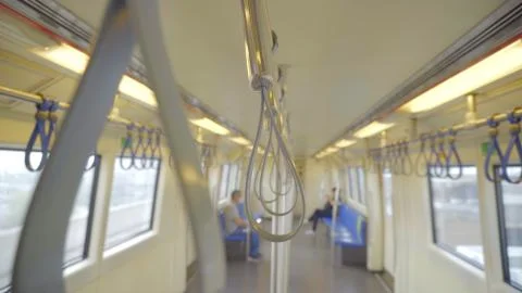 Closeup handle loop in a sky train with blurry people background. Foto stock