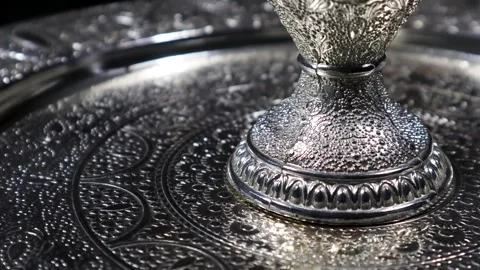 A closeup of handmade designs on a silverware set, while it is rotating Stock Footage 263042641
