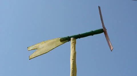 Closeup of handmade pinwheel spin in wind on blue sky background Stock Footage 32456868