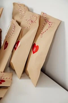 Closeup Handmade rustic advent calendar bags with small gifts for christmas eve Stock Photos