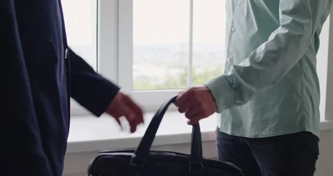 Closeup handoff of briefcase hints at bribe, cash payoff and corruption scheme Stock Footage 336749181