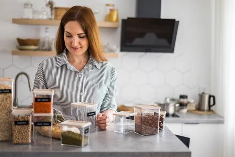 Closeup hands adding healthy pea pasta into transparent box. Storage Stock Photos
