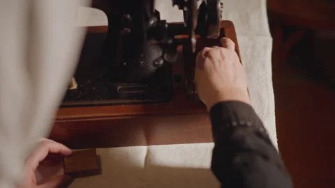 Closeup hands adjusting sewing machine components, maintenance worker oils Stock Footage 346550061