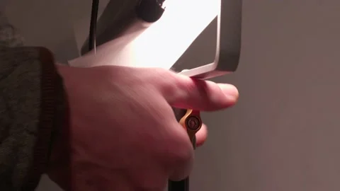 Closeup of hands adjusting white diffusion lighting gel on stand, studio, Vidéo 150822699