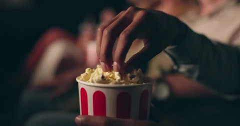 Closeup, hands and man with popcorn, cinema and movie theater with audience and Stock Footage 268957956