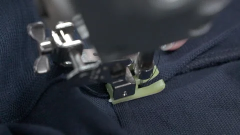 Closeup of Hands and Sewing Machine in a Vietnam Garment Factory Video stock 247416398