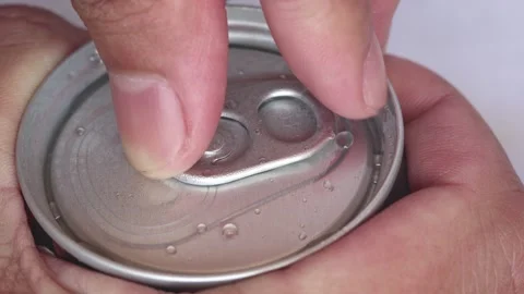 Closeup hands are opening aluminum can of coffee with a gas inside. Stock Footage