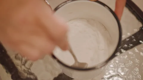 Closeup of hands blending flour and sugar for pumpkin pie. Action shot of hands Stock Footage 346393538
