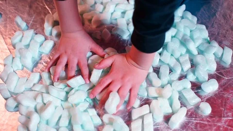 Closeup of the hands of a boy touching sugar candies. Stock Footage 123698569