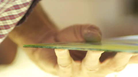 Closeup of hands breaking a piece of stained glass Stock Footage 33063353