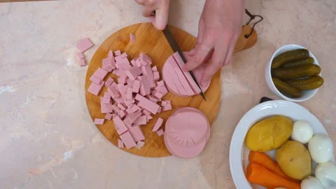 Closeup of hands chopping various ingredients for family meal preparation Vídeo Stock 331152694