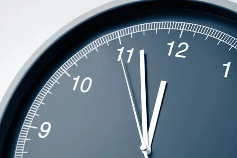 Closeup of hands on clock face. 12 o'clock Stock Photos