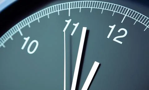 Closeup of hands on clock face. 12 o'clock Stock Photos