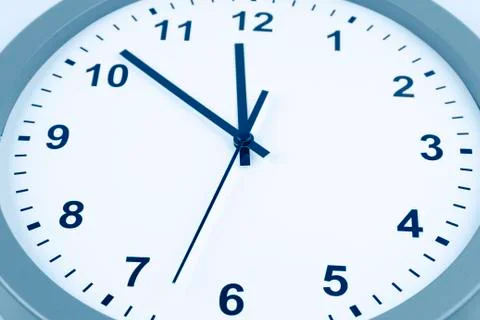 Closeup of hands on clock face Stock Photos