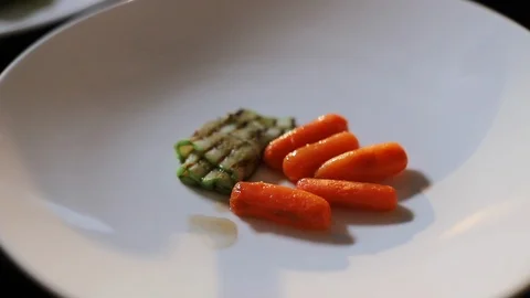Closeup Of Hands Of Cook Putting Piece Of Fish On Carrots And Zucchini. Dish On Stock Footage 120574772