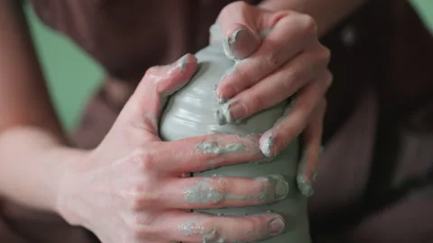 Closeup hands covered in clay finishing vessel, fingertips imprinting texture Stock Footage 337362861