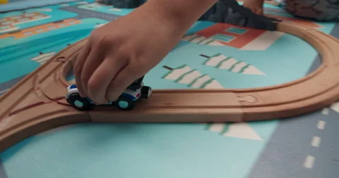 Closeup hands Cute happy boy playing wooden railway road toy in children's room Video stock 164686265