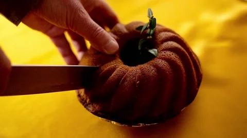 Closeup of hands cutting bundt cake, super slow motion Stock Footage 103845686