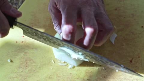Closeup hands cutting onion into half rings on kitchen board Stockbeeldmateriaal 316203567