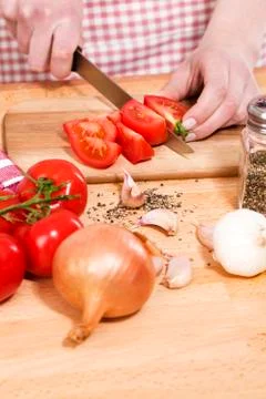 Closeup of hands cutting tomatoes Stock Photos