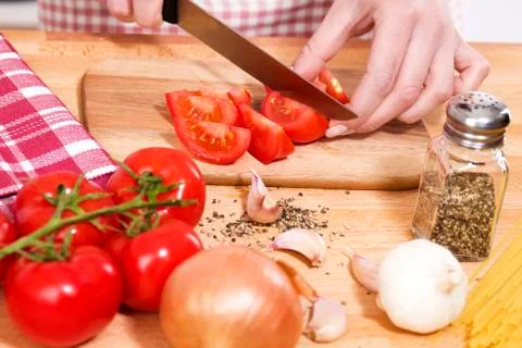 Closeup of hands cutting tomatoes Stock Photos