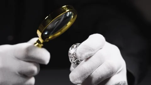 Closeup of hands of diamond expert in process of evaluating polished diamonds us Stock Footage 312676502