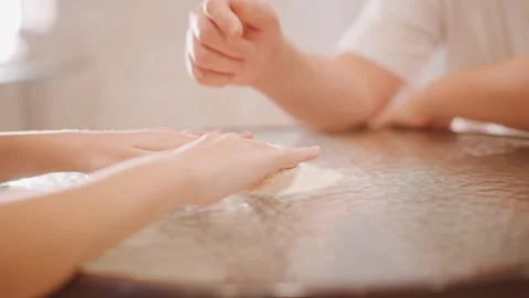 Closeup of hands dusted with flour creating pumpkin pie dough. Warm kitchen Stock Footage 348302519