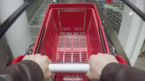 Closeup of hands with empty plastic red shopping cart or shopping basket in Stock Footage 129832096