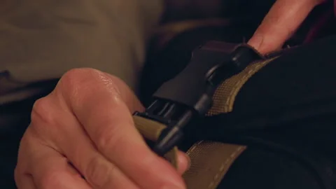 Closeup of hands fastening backpack in evening light moments. Preparation for Stock Footage 337368695