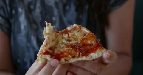 Closeup of hands grasping sizzling pizza slice with melted cheese Видео 331942765
