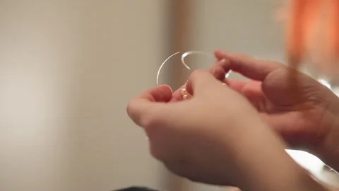 Closeup hands holding crystal pendulum over beads, fortune reading ritual with 動画素材 346560156