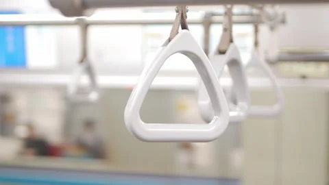 Closeup of Hands holding handrail or handheld grip straps in metro subway t.. Video stock 303645917