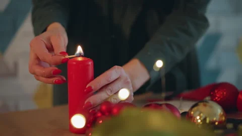 Closeup of hands igniting candle. Delicate match sparks ignite candle wick Stock Footage 338285717