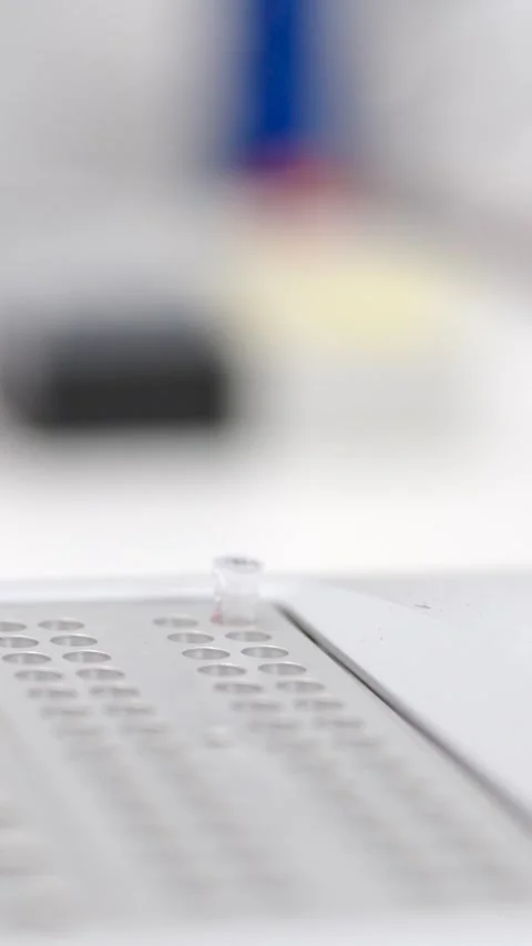 Closeup of hands introducing samples in machine Stock Footage 257379356