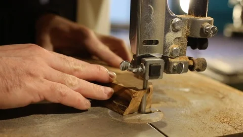 Closeup of hands of a joiner process a tree on a band saw. Production of wooden  動画素材 123454240