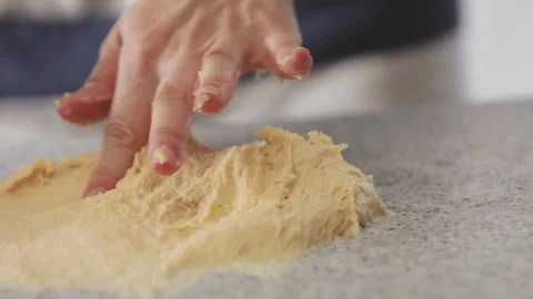 Closeup hands kneading flour dough isolated on kitchen wood table backgroun.. Stock Footage 272467133