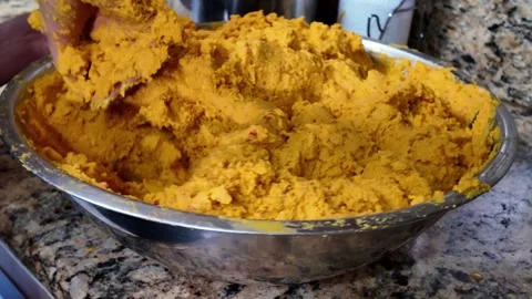 Closeup of hands kneading yellow corn dough for traditional Latin Food tamales Stock Footage 327607319