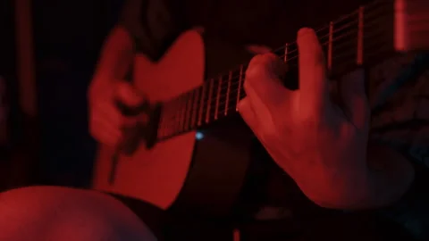 Closeup of hands of a Man Playing a Guitar in the Dark 스톡 동영상 258347073
