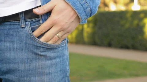Closeup of hands. the man takes off his wedding ring standing on the street. Stock Footage 126290291