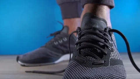 Closeup of hands Man is tying shoe laces. male sport fitness runner getting Video stock 101189991