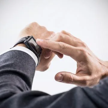 Closeup hands of man using his smartwatch. Stock Photos