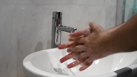 Closeup on the hands of a man while performing a scrupulous wash Video stock 123964972