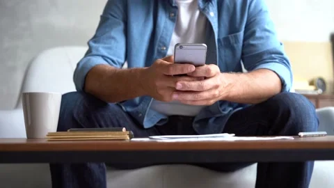 Closeup hands of mature man using smartphone, typing message on mobile phone. Stock Footage 141184323