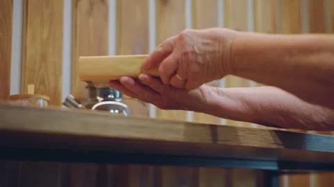 Closeup hands opening book at table, white grandma flips worn pages, wooden Stock Footage 345149984
