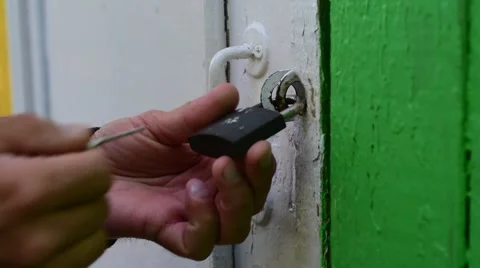Closeup of hands opening a padlock Stock Footage 66693298