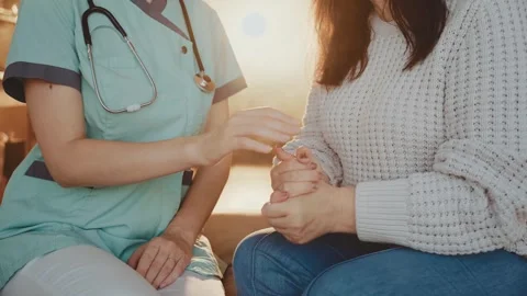 Closeup hands person is nervous under stress, mature sad woman listens to Stock Footage 323458640